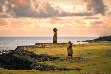 The moai statues of Ahu Ko Te Riku and Ahu Tahai at the Tahai Archaeological Site on Rapa Nui (Easter Island), Chile, stand against the Pacific Ocean that stretches behind. UNESCO world heritage site.