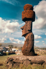 Side view of moai statue with a topknot and beautifully adorned ears. It is located in the Hanga Vare Vare open green space along the Hanga Roa coastline, Rapa Nui (Easter Island), Chile.