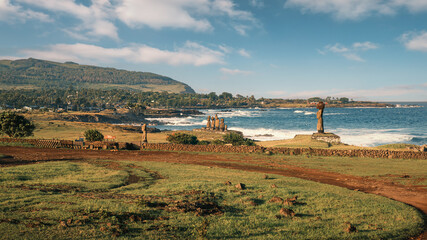 The Tahai Archaeological Site on Rapa Nui (Easter Island), Chile, lit by soft morning light. It merges remnants of significant historical value with a stunning landscape facing the Pacific Ocean.