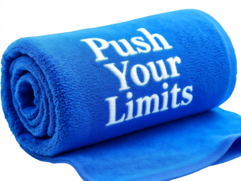 A blue rolled towel with the words push your limits printed on it, representing motivation and determination isolated on transparent background