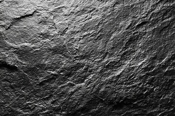 Close-up view of dark gray stone surface with rough texture (2)