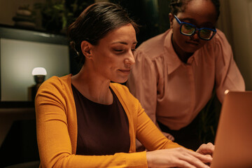 Two office workers discussing late at night