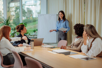 Businesswoman listening to the presentation in the glass office