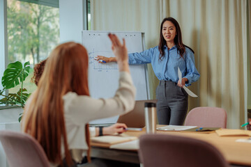 Businesswoman asking a question during a presentation