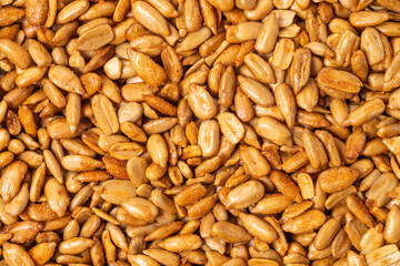 Peeled sunflower seeds in teriyaki sauce as a texture, background, pattern