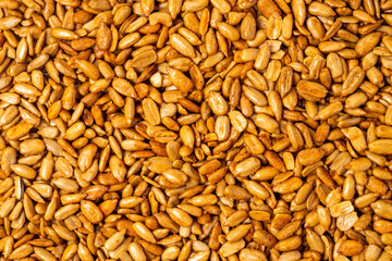 Peeled sunflower seeds in teriyaki sauce as a texture, background, pattern
