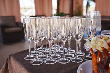 Elegant glassware arranged for a festive gathering at a sunny outdoor venue