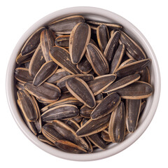 Big sunflower seeds in a shell in a round plate isolated on white background, top view