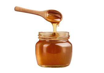 Honey dripping from wooden spoon into glass jar
