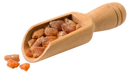 Crushed amber in the wooden scoop, isolated on white background.