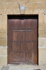 Old wooden door in a stone facade
