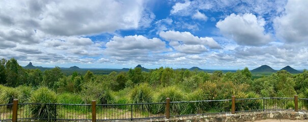 Panoramic view of Glass House Mountains View with Lush Vegetation and Rustic Fence in Queensland, Australia © Heavenlyflower
