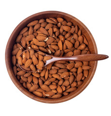 Almonds in a large wooden bowl with spoon isolated on white background, top view	