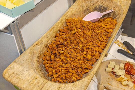 Traditional Balkans Cuisine Pig Pork Rind Cvarci in Bulk at Wooden Trough
