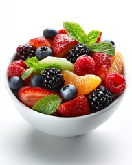 bowl of fresh fruit salad with berries and mint, healthy breakfast food isolated on white