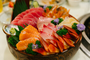 Japanese food raw fish mixed sashimi in brown wooden bowl
