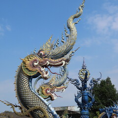 Obraz premium Wat Rong Suea Ten,Ornate architecture, Buddha and figures in the Blue Temple in Chiang Rai, Thailand, Asia