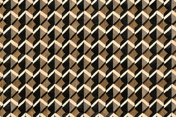 Geometric pattern with brown and beige tones on a black backdrop. Abstract design with repeating. three-dimensional shapes.