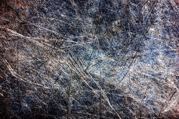 Scratched metal surface texture closeup. Distressed industrial steel background with colorful patina. Detailed grunge pattern with random lines. Rough aged metal for design.