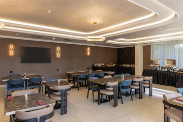 Interior of a modern hotel restaurant with ceiling lighting