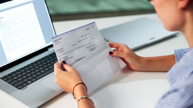 Work Compensation: Holding Payroll Check Envelope