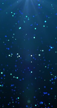 Particles bokeh floating in blue background. Loop. 4K Vertical