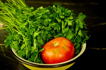 tomato and parsley are lying on a plate
