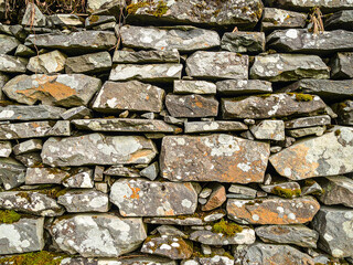 White cracked plaster wall texture. Grunge background with peeling paint and damaged surface detail.