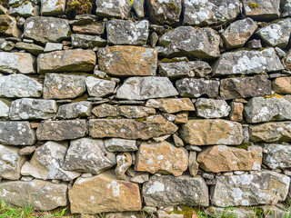 White cracked plaster wall texture. Grunge background with peeling paint and damaged surface detail.