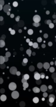 Bokeh floating in black background. Loop. 4K Vertical