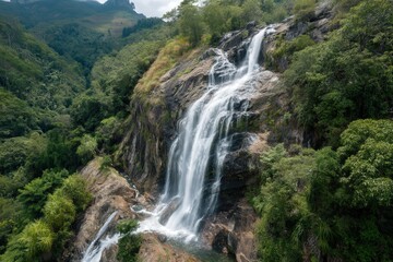 Fototapeta premium Majestic waterfall cascading down rocky cliffs in a lush forest setting