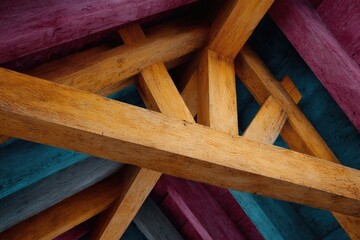 A crisscrossing pattern of wooden beams in varying colors showcasing a unique geometric design
