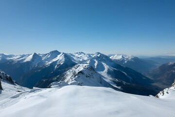 Fototapeta premium Stunning snow-covered mountain range under clear blue sky perfect for travel ads