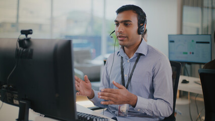 Focused tech support agent from call center providing excellent customer service. professional operator with headset offering assistance during remote video call