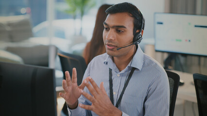 Corporate customer service team including Indian business man and black woman in headset, consulting clients, handling telemarketing, CRM solutions, phone calls and professional communication