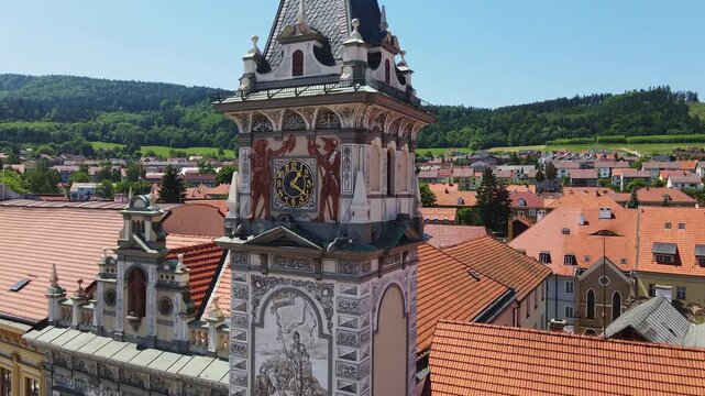 Cinematic aerial of decorated clock tower in Prachatice Old Town, Czech Republic
