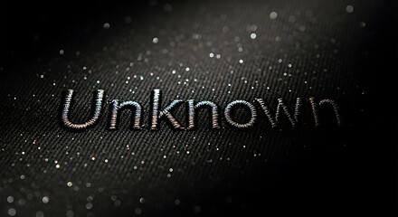 Unknown Word Embroidered on Dark Fabric