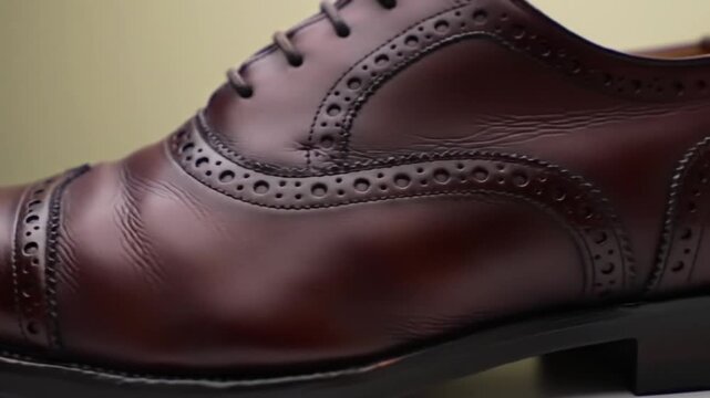Elegant brown leather brogue shoe detail, showcasing classic craftsmanship and style.
