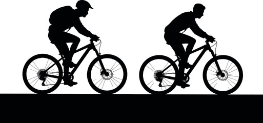 Obraz premium Silhouetted cyclists in action riding mountain bikes on a trail during the day