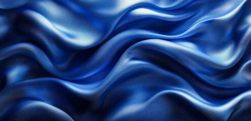 Fototapeta premium Blue silk draping fabric. Deep blue silk fabric creates a wave-like pattern, showcasing its smooth texture and reflective surface effortlessly.