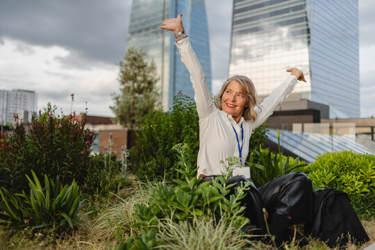 Executive leader posing inspired in urban garden with office towers