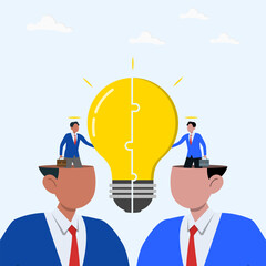 Two businessmen sharing a large light bulb between their open heads. Symbolizing idea exchange, teamwork, collaboration, innovation and knowledge sharing.