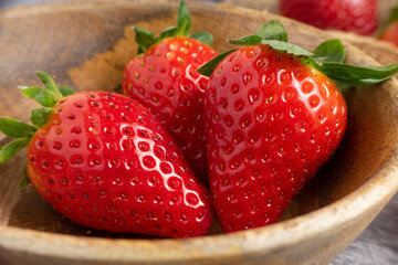 Fresh strawberries with green leaves arranged close up