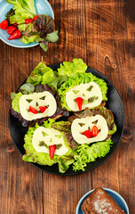 Mini sandwiches with monster faces.