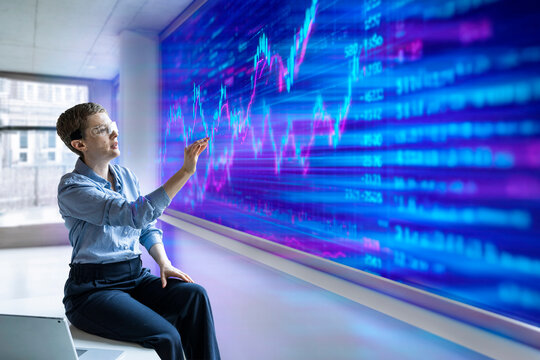 Professional using AR glasses analyzes financial data on virtual screen