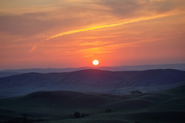 Sun rises over a picturesque mountain valley