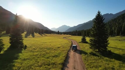 Epic Journey: Aerial Drone Follows SUV on a Winding Dirt Road Through a Golden Mountain Valley - Powered by Adobe