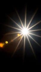 Fototapeta premium Starburst lens flare illuminating a dark canvas, creating a celestial and bright abstract feel.