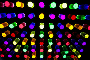 Backlit plexiglass cylinders in various colors, used by small children to create shapes on panels