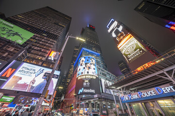 New York City - June 14, 2025: Nighttime view of Times Square featuring illuminated billboards,...